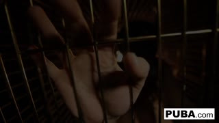 Busty brunette fucks herself in a kennel!